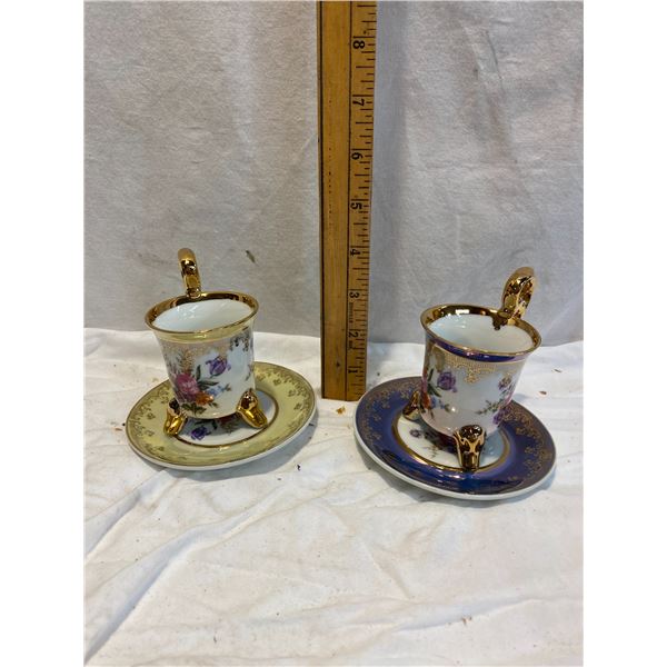 Two footed cups and saucers