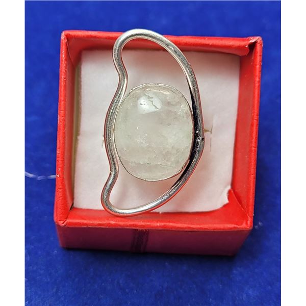 11)  LARGE OVAL NATURAL MOONSTONE RING IN AN