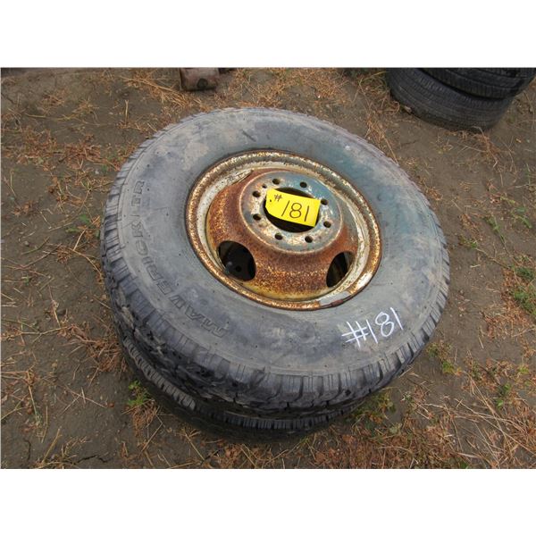 2- 235/85/16 GRIP TIRES ON 8 HOLE RIMS