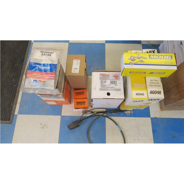 lot of assorted auto parts-filters, calipers, brake, battery, bulb