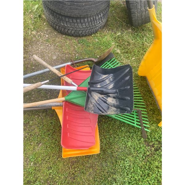 lot of snow shovels, rakes, etc