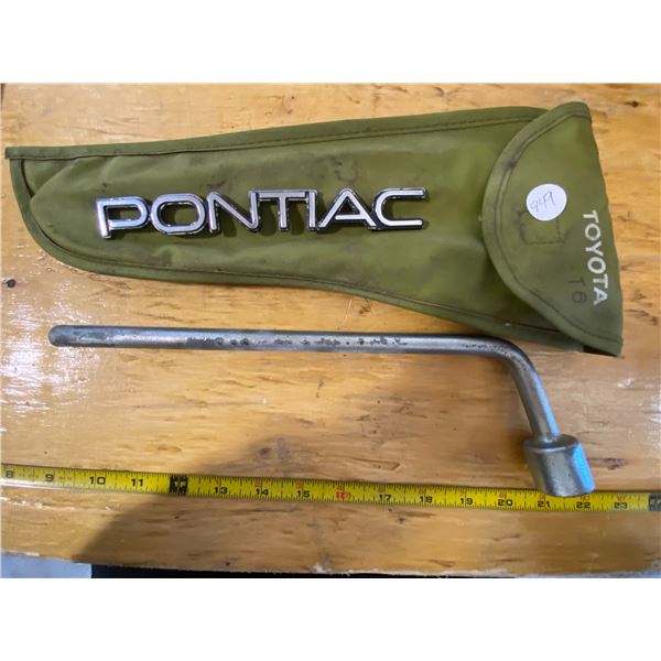 1995 Pontiac Emblem and a Toyota T6 Tire Iron with case