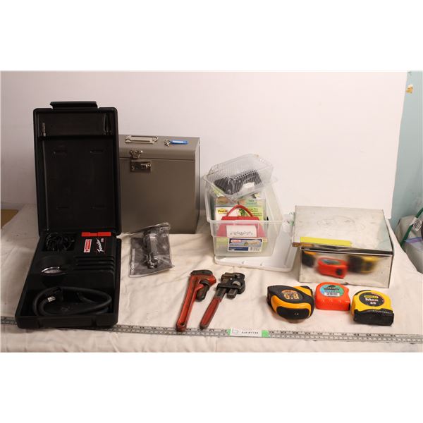 Small Storage box with key, motomaster portable air compressor, tape measures, pipe wrenches