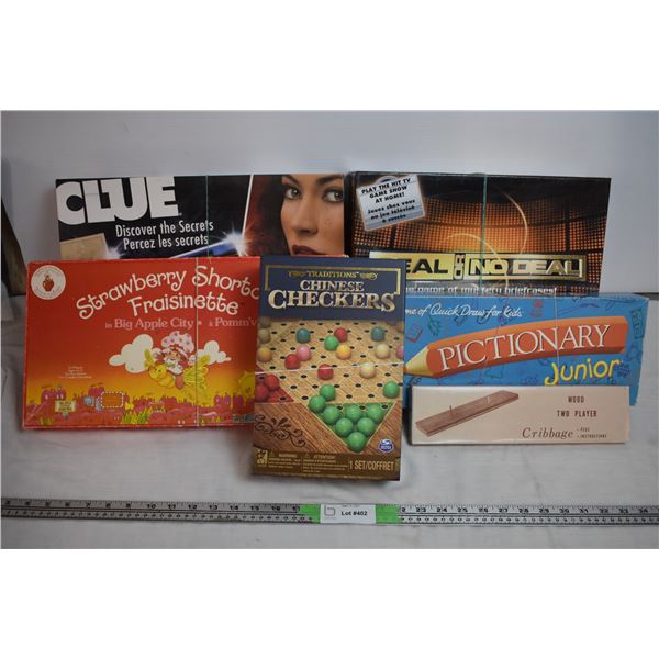 Box of board games - Strawberry shortcake, wood cribbage board, Clue, misc