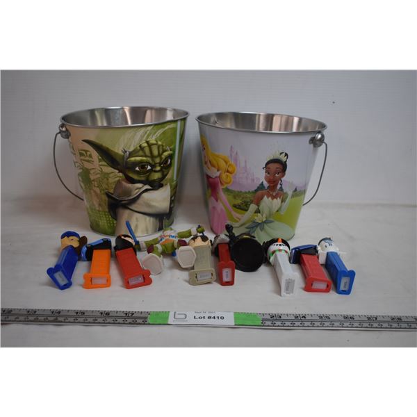 Two tin sand buckets with pez dispensers
