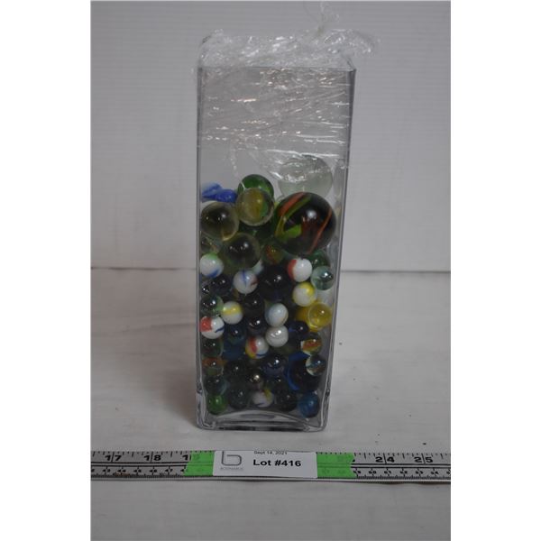 Vase full of marbles, some large ones