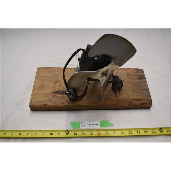 Metal Fan on plank of wood