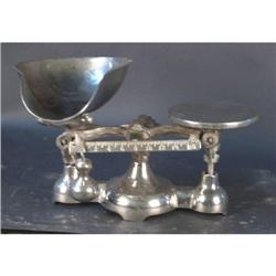 Balance scale with scoop silver in color