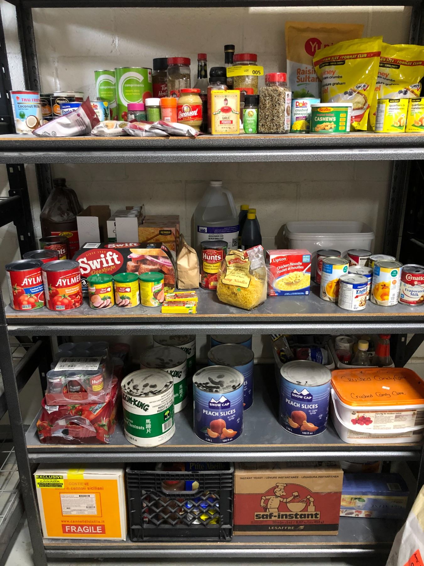 Unopened Food Four shelves of assorted unopened food products - can foods/dry food ...