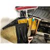 Image 2 : Black plastic trash bin-filled w/assorted brooms and shovels