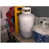 Image 2 : Approx. 4'x2' metal shelving unit & contents - 2 propane tanks/gasoline jerry cans/yard sprinklers/e