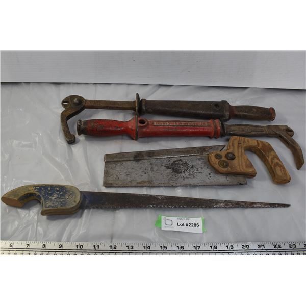 two nail pullers and 2 vintage handsaws
