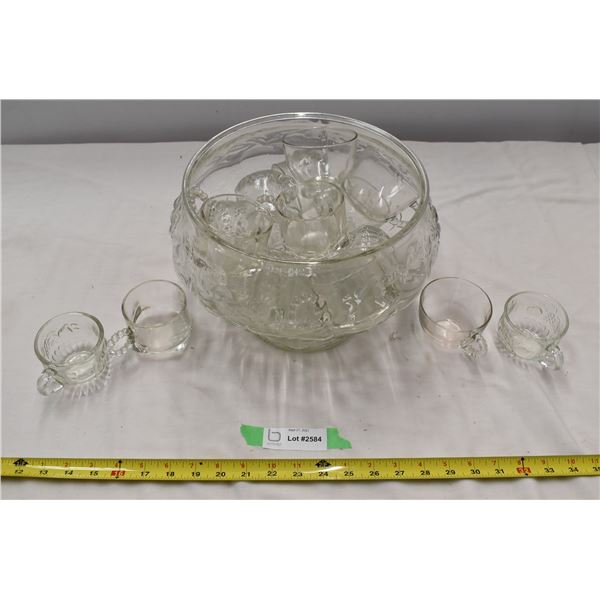 Glass bowl filled with glass mugs