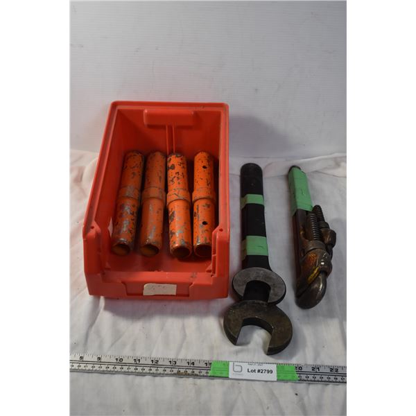 Storage container with Large wrenches, metal pipes, and pipewrench