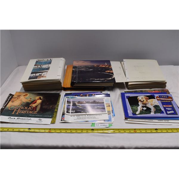 2 photo books with pile of extra pages, misc. calendars