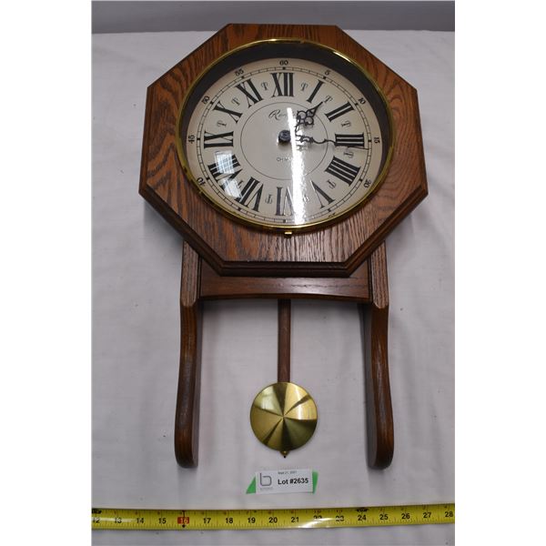 Wall hanging Rensie clock. Swinging pendulum