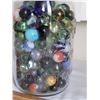 Image 3 : Assorted large and small fancy marbles in a mason jar.
