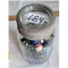 Image 4 : Assorted large and small fancy marbles in a mason jar.
