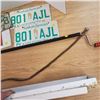 Image 3 : misc lot Exit sign matching license plate pair , vent cover, plumbers snake