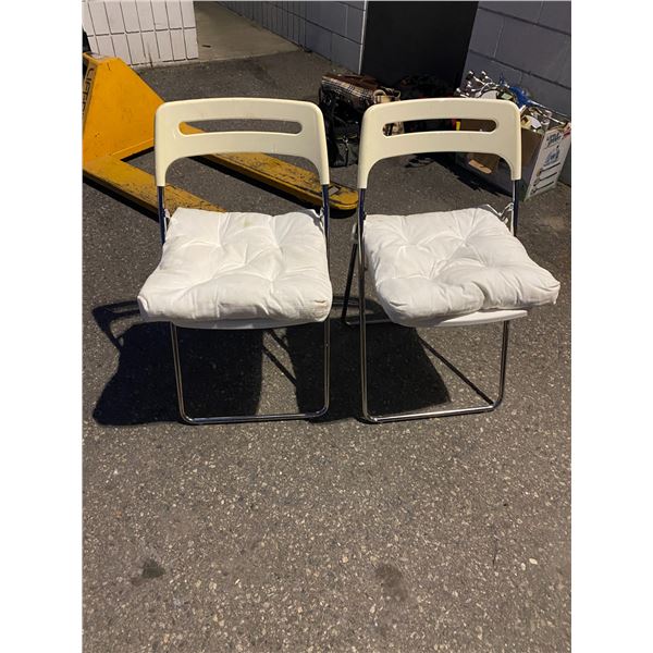 Two folding chairs one has crack