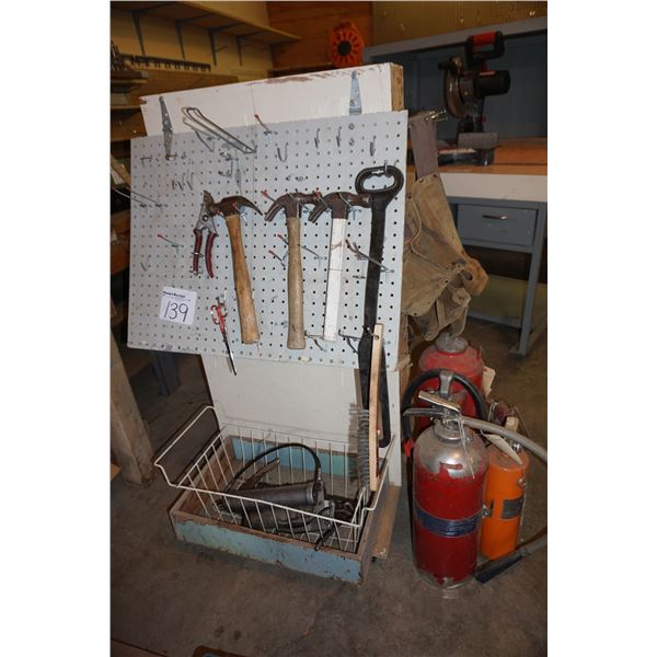 Stand with Hammers, Grease Guns, Fire Extinguishers.