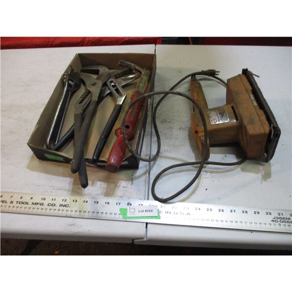 black N decker sander, pliers, nail puller, crescent wrenches