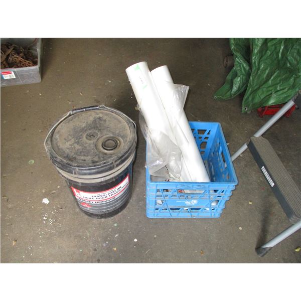 2 partial rolls of plastic, with hydraulic fluid pail (1/2 full?)