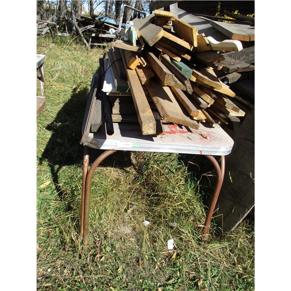 Table with misc lumber, misc items
