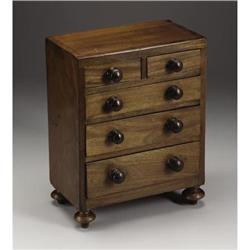 A Victorian miniature chest of drawers