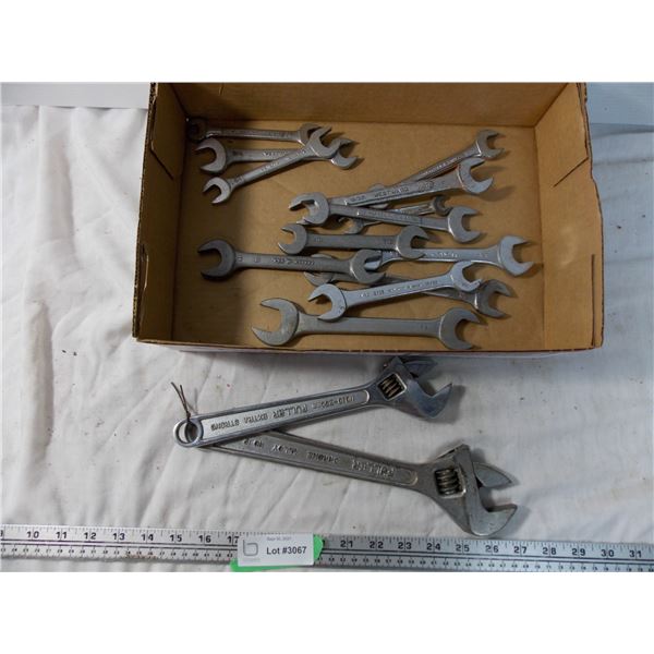 pair of crescent wrenches with various wrenches
