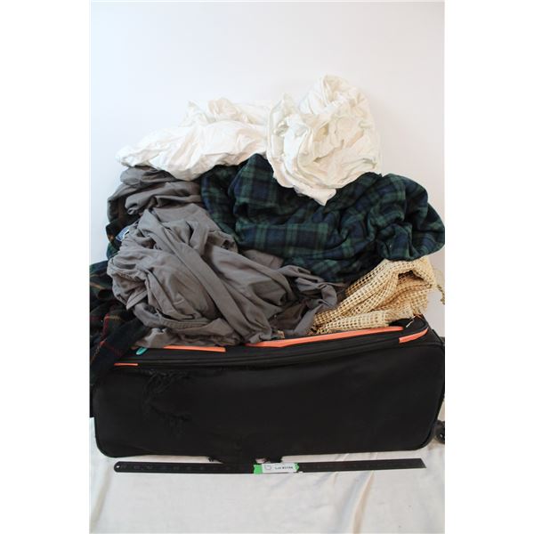 Luggage bag with assorted bedding and blankets