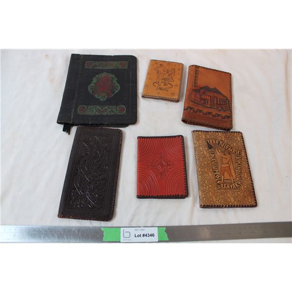 Leather dust jacket, leather notebook, and leather wallets