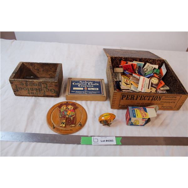 Wooden boxes, one filled with matches, and a metal pecking chicken