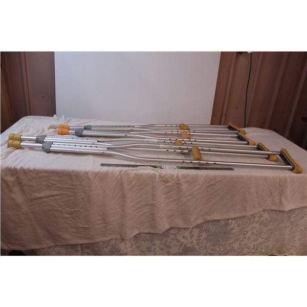 Two sets of metal crutches, one max size of 6’6”, one max size of 5’10”