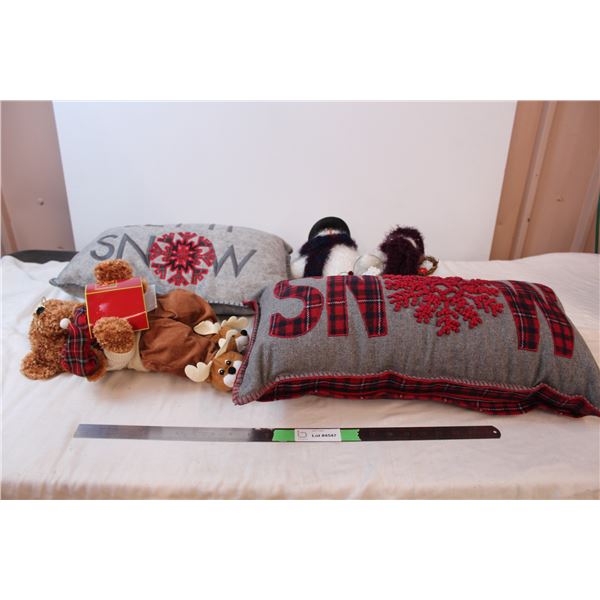 Decorative holiday pillows, snowman family, and story teddy bear