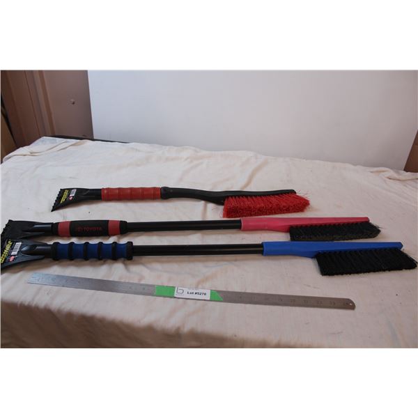 Three snow brushes