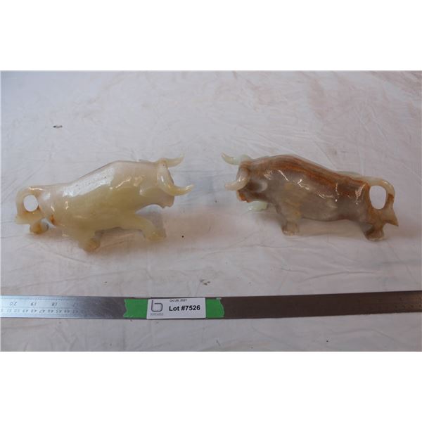 Polished stone bull carvings, one repaired