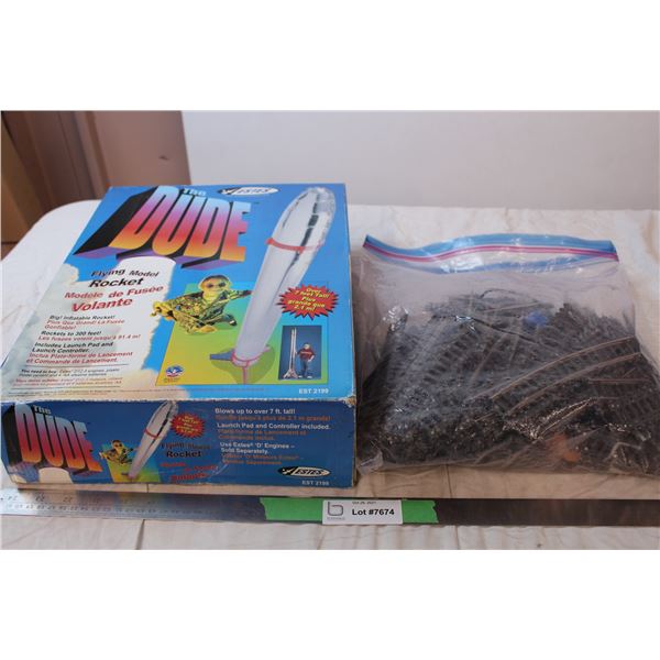 “The Dude” Flying model rocket sealed in box, mechanical train tracks