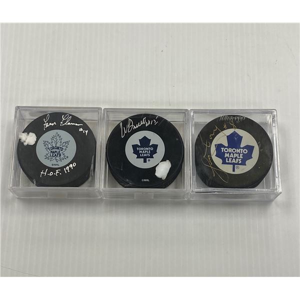 Three Signed Hockey Pucks (Fern Flaman, Pat Boutette,