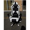 Image 1 : AS NEW BLACK AND WHITE GAS LIFT GAMING CHAIR - cracked casing on right side spring cover