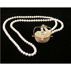 A PEARL NECKLACE WITH GOLD NANTUCKET BASKET PENDANT