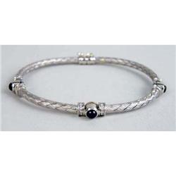 AN ITALIAN 18K WHITE GOLD DIAMOND AND SAPPHIRE BASKET-WEAVE MOTIF HINGED BANGLE BRACELET