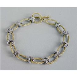 A YELLOW AND WHITE GOLD ROPE-FORM LINK BRACELET