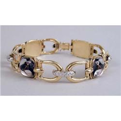 AN UNMARKED YELLOW GOLD DIAMOND AND CRYSTAL HORSE MOTIF PLAQUE BRACELET