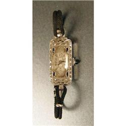 A PLATINUM, DIAMOND AND ONYX WATCH