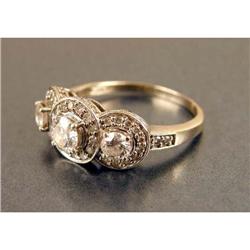 A 14K WHITE GOLD AND DIAMOND THREE-STONE RING