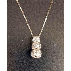 A 14K WHITE GOLD AND DIAMOND THREE STONE PENDANT