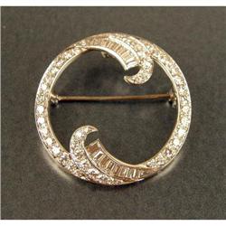 A PLATINUM AND DIAMOND CIRCLE BROOCH