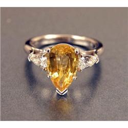 A PLATINUM, YELLOW SAPPHIRE AND DIAMOND RING