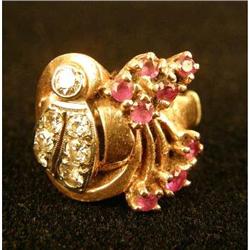AN UNMARKED ROSE GOLD DIAMOND AND RUBY RING